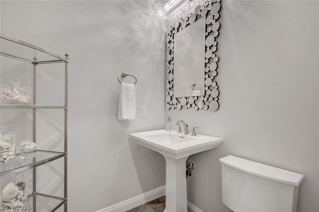 274 Evante Street, Las Vegas, NV 89138 A chic pedestal sink and an artfully framed mirror add elegance to this well-appointed bathroom.