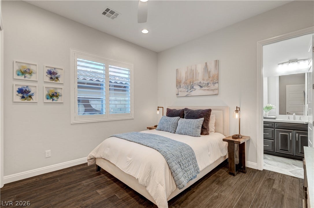 274 Evante Street, Las Vegas, NV 89138 Rich hardwood flooring creates a warm and inviting atmosphere in this well-appointed bedroom, featuring a window with privacy shutters.