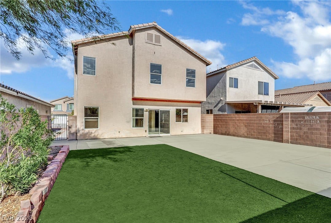 5823 Golden Wing Street, Las Vegas, NV 89113 A spacious concrete patio and vibrant green turf extend from the rear of this inviting residence.