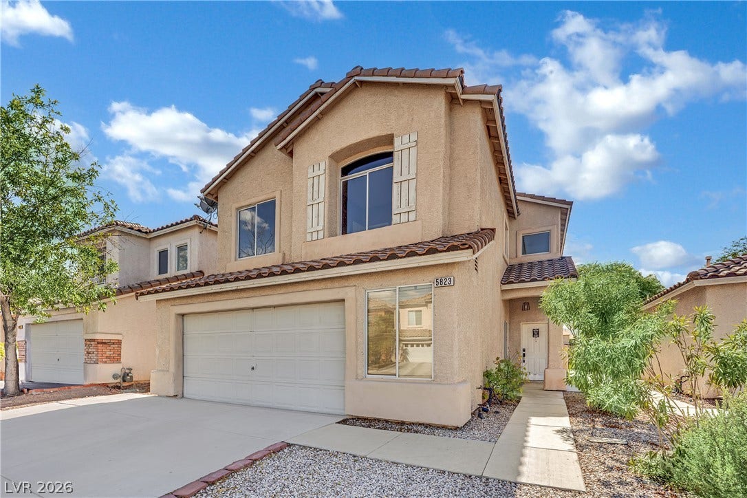 5823 Golden Wing Street, Las Vegas, NV 89113 A terracotta-tiled roof crowns this residence, featuring an attached garage and desert-friendly landscaping.