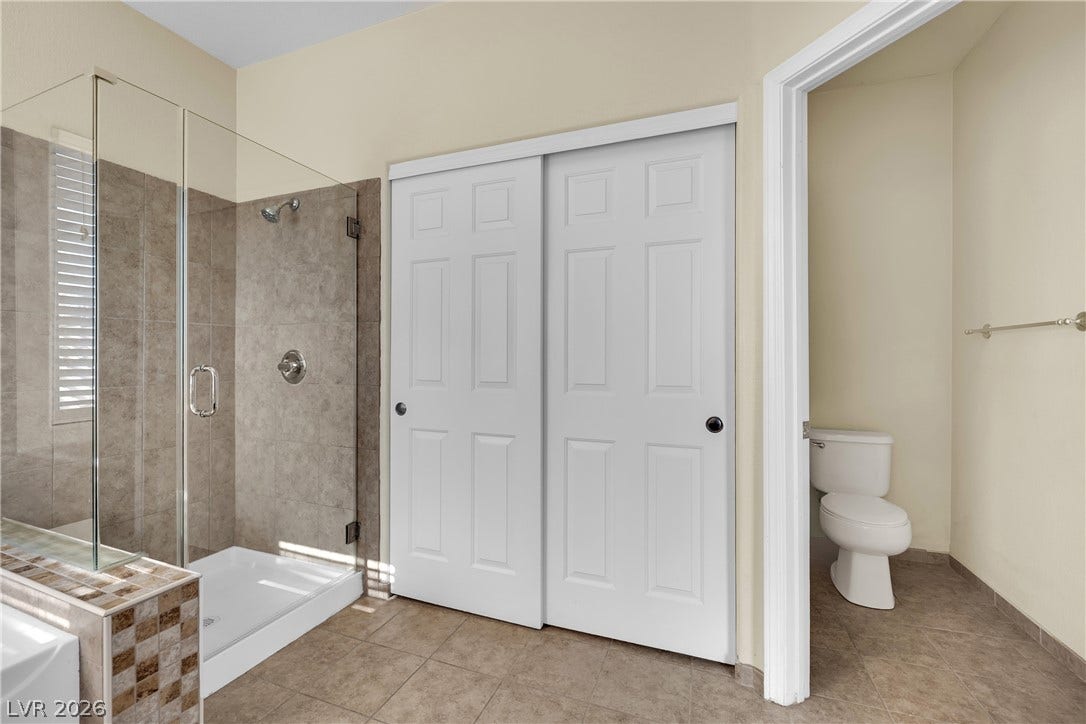 5823 Golden Wing Street, Las Vegas, NV 89113 A well-appointed bathroom offers a glass-enclosed shower and convenient closet space.