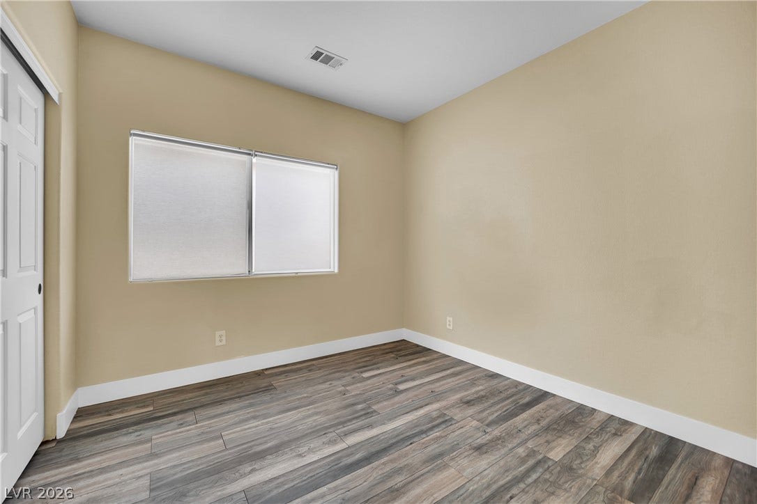 5823 Golden Wing Street, Las Vegas, NV 89113 Laminated flooring and generous natural illumination create a welcoming bedroom space.