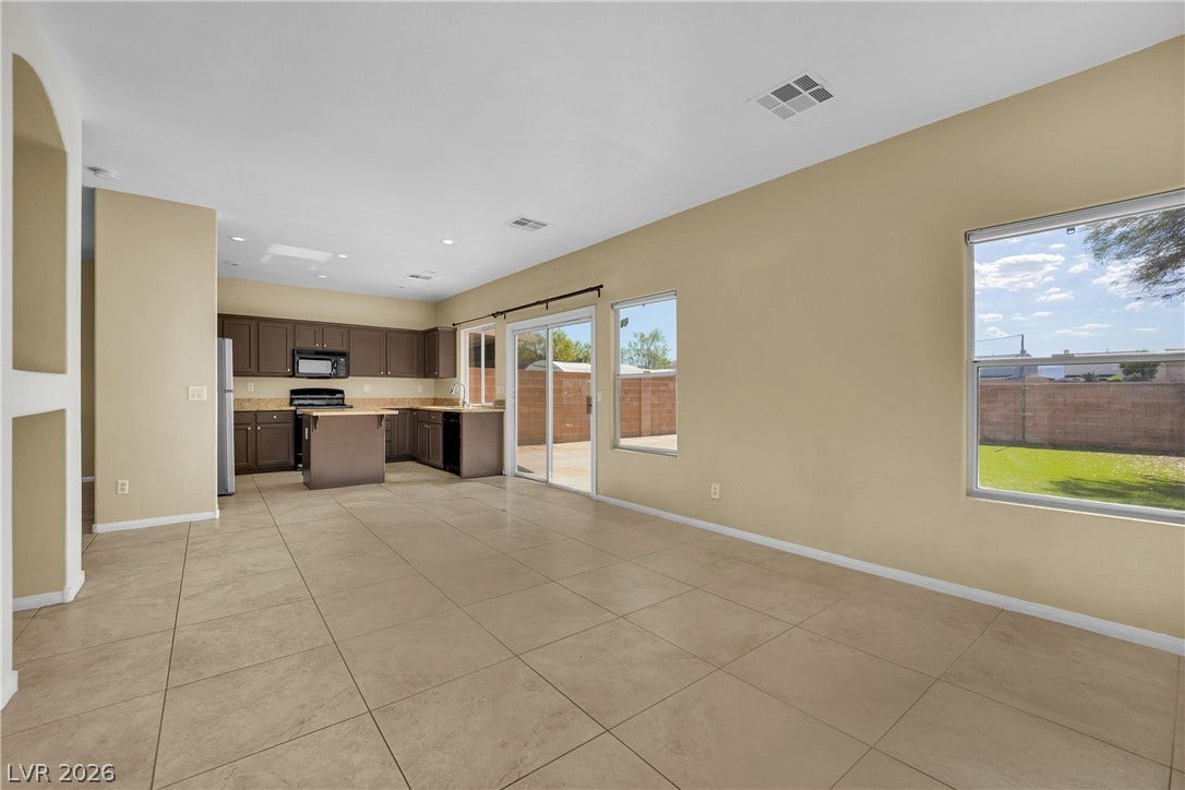 5823 Golden Wing Street, Las Vegas, NV 89113 An open-concept living space features a functional kitchen and inviting outdoor access.