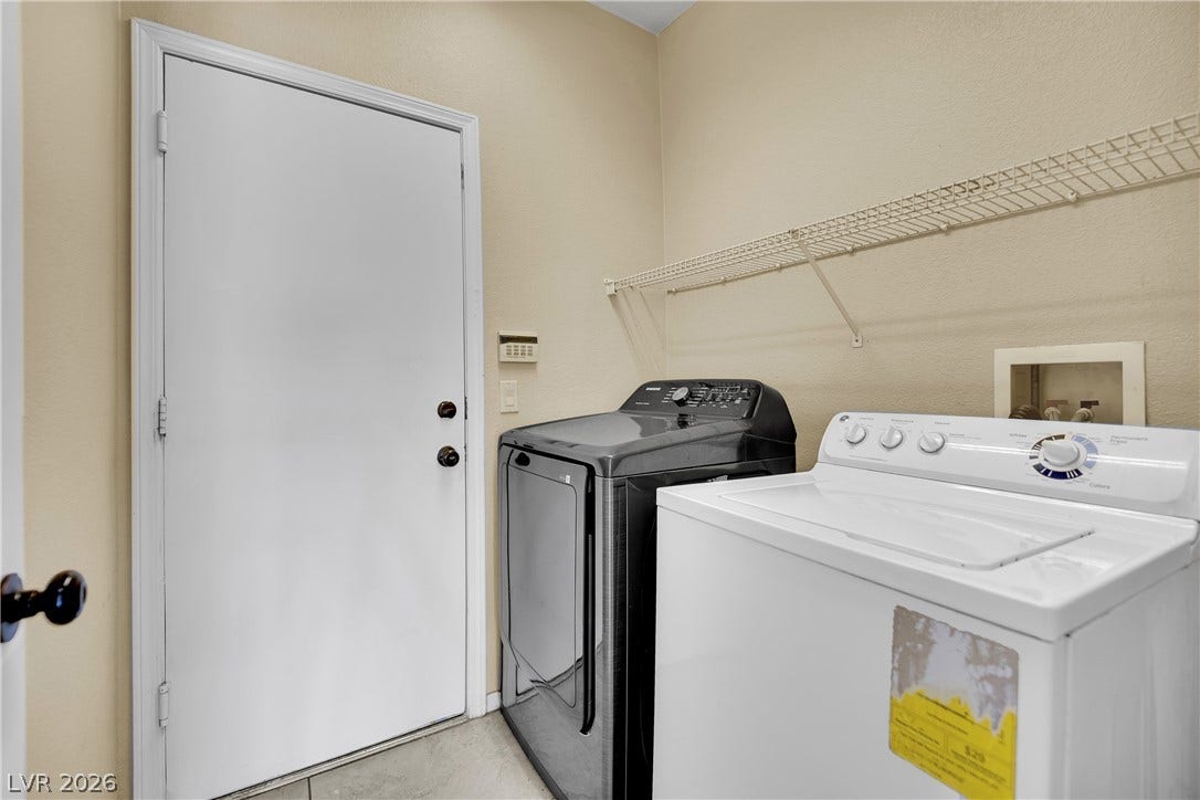5823 Golden Wing Street, Las Vegas, NV 89113 Functional laundry space featuring modern appliances and convenient overhead shelving.