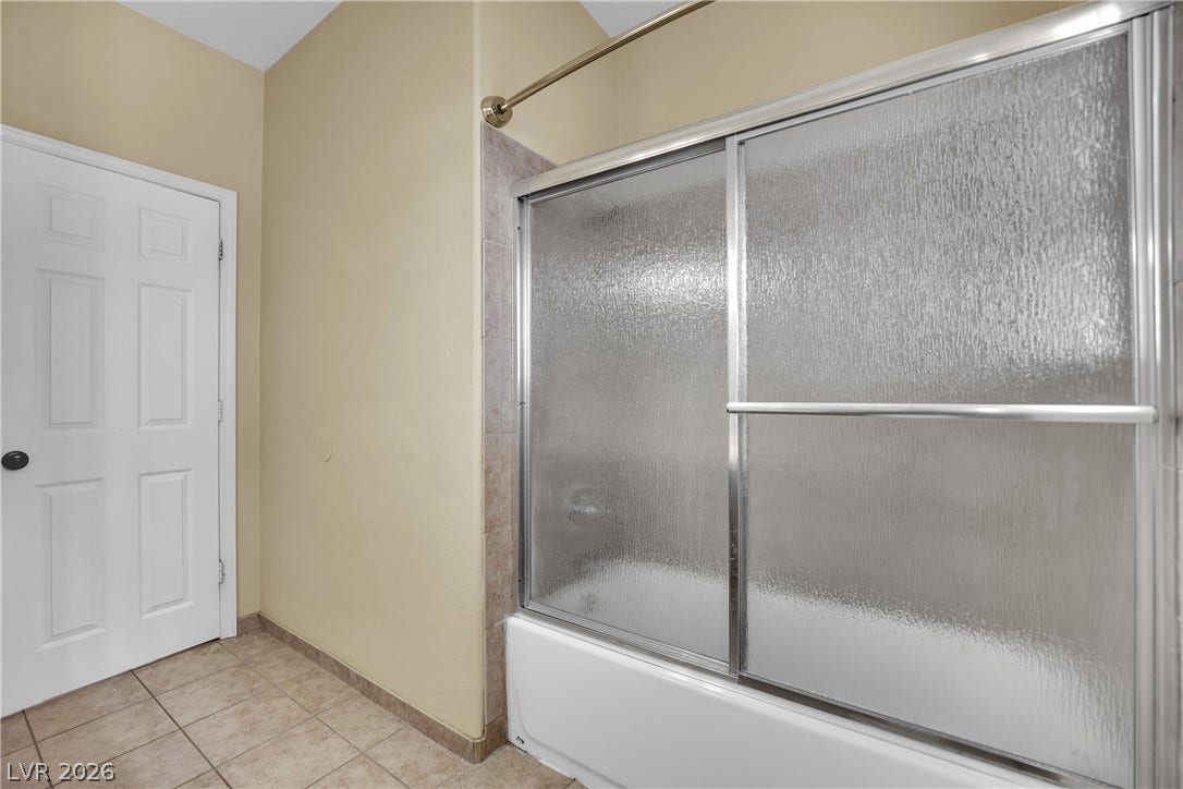 5823 Golden Wing Street, Las Vegas, NV 89113 Functional bathroom featuring a tub and shower combination, complete with sliding glass doors.