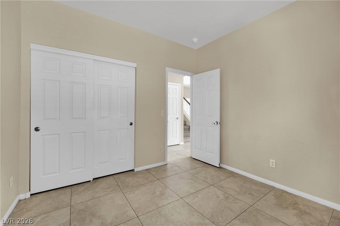 5823 Golden Wing Street, Las Vegas, NV 89113 Neutral-toned tile flooring extends through this versatile room, featuring ample closet space and access to the rest of the home.