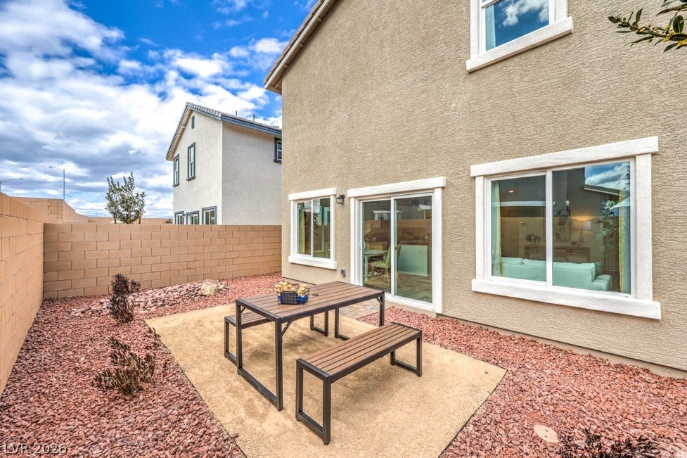 1090 Saffron Toucan Lane, Henderson, NV 89011 Fenced backyard featuring a patio area and outdoor dining space. Home is representational only; actual home finishes may vary.