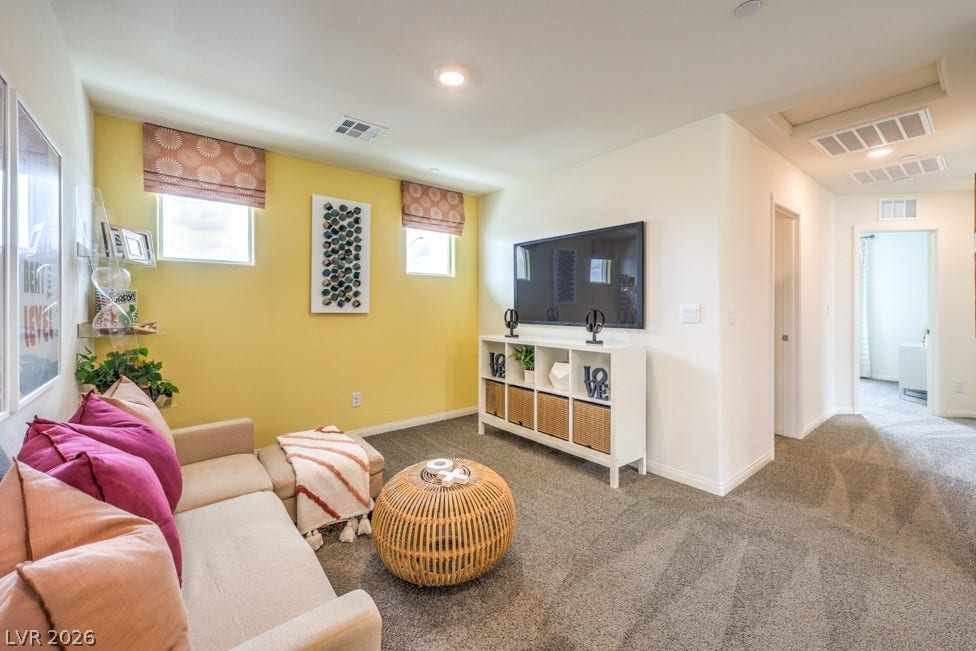 1090 Saffron Toucan Lane, Henderson, NV 89011 Carpeted living area featuring baseboards. Home is representational only; actual home finishes may vary.