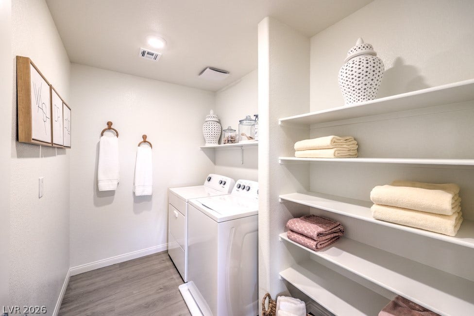 1090 Saffron Toucan Lane, Henderson, NV 89011 Washroom featuring light wood finished . Home is representational only; actual home finishes may vary.floors and separate washer and dryer