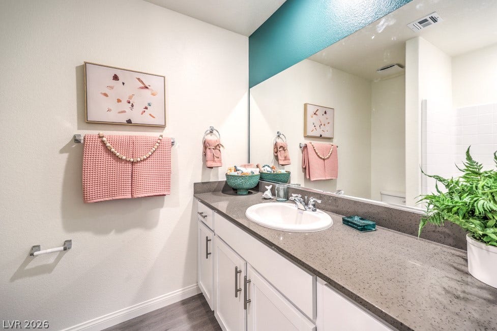 1090 Saffron Toucan Lane, Henderson, NV 89011 Full bath with vanity and dark wood-style flooring. Home is representational only; actual home finishes may vary.