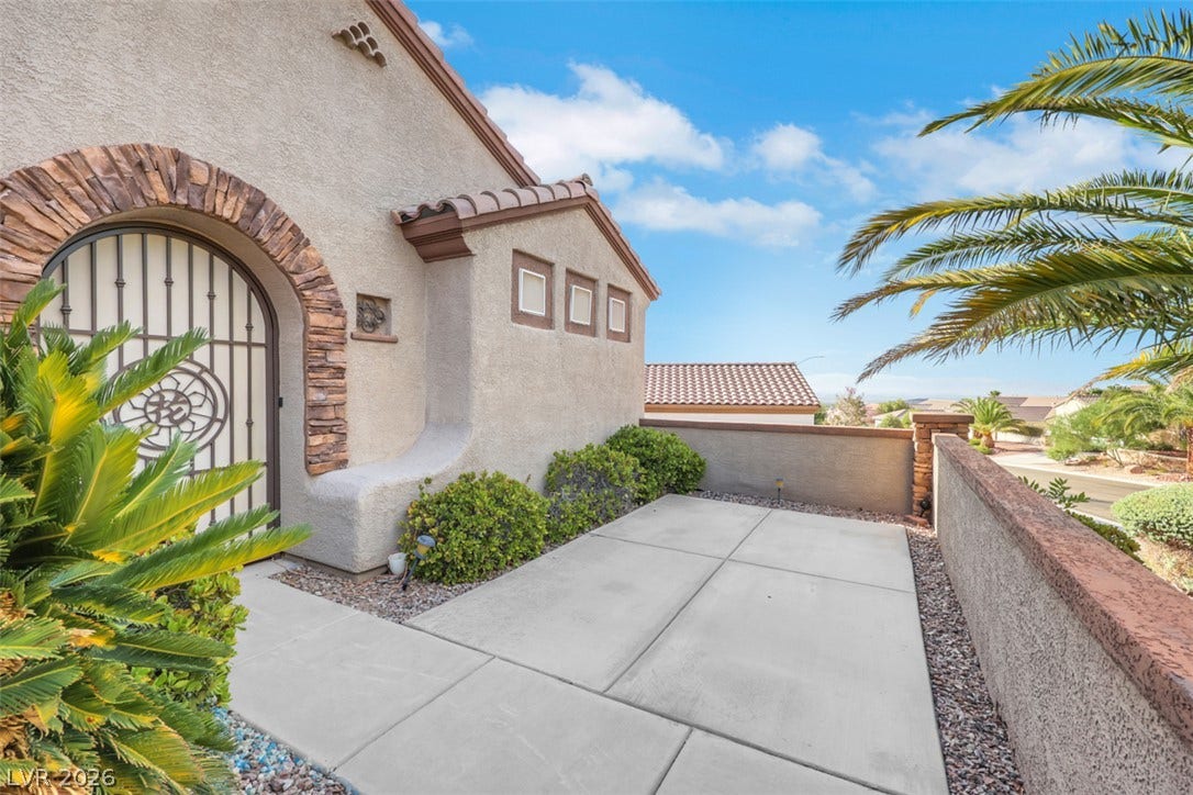 A striking arched entry with intricate ironwork welcomes you to this desert oasis.