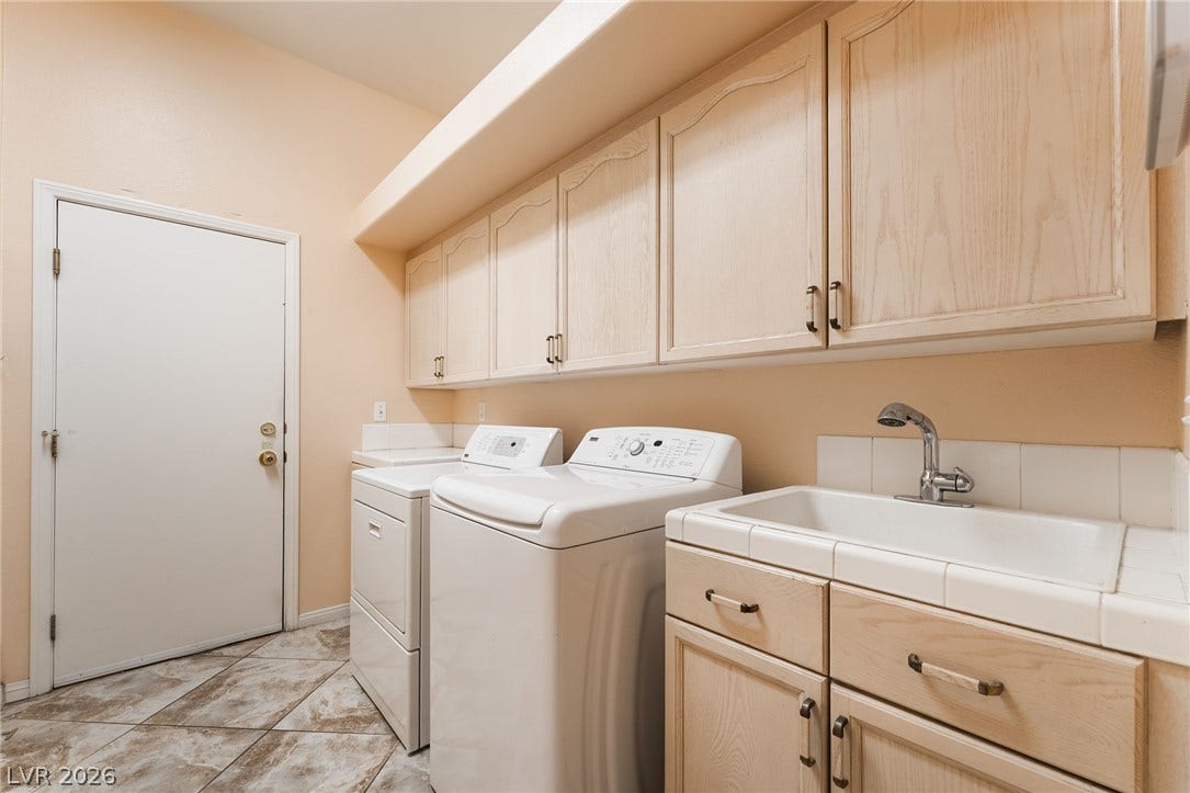 3775 Rick Stratton Drive, Las Vegas, NV 89120 Functional laundry space featuring convenient storage cabinetry and a practical utility sink.