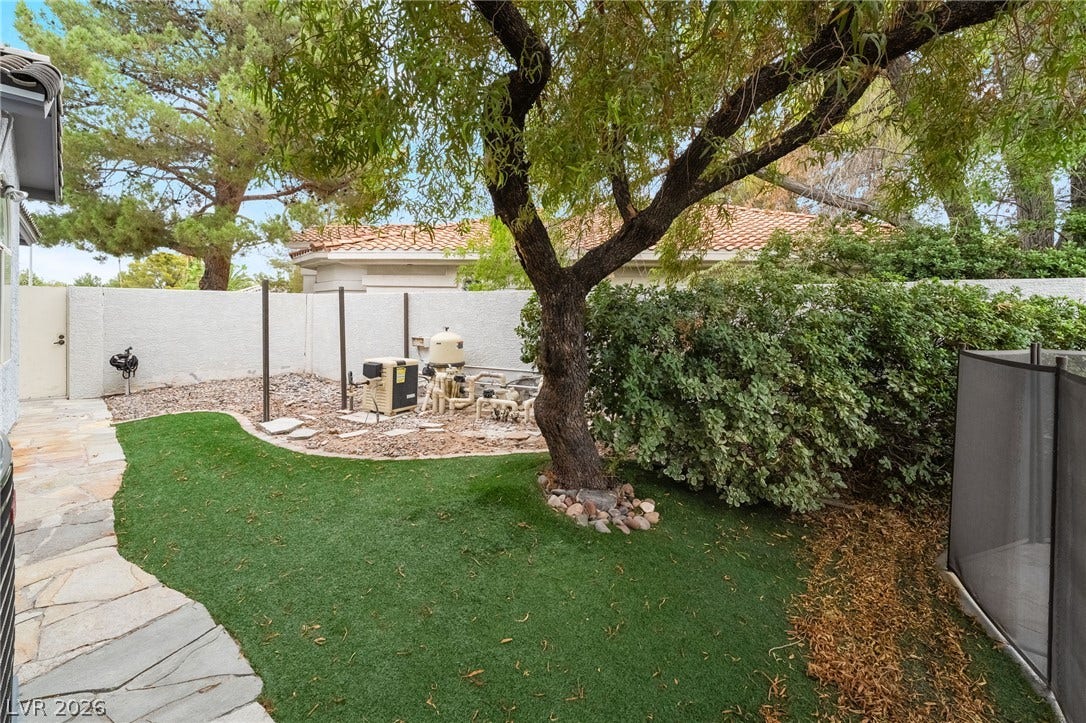 3775 Rick Stratton Drive, Las Vegas, NV 89120 A private, low-maintenance yard features artificial turf and a mature shade tree.