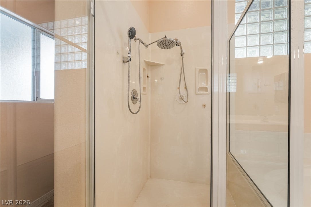 3775 Rick Stratton Drive, Las Vegas, NV 89120 A spacious, enclosed shower with multiple showerheads offers a rejuvenating experience.