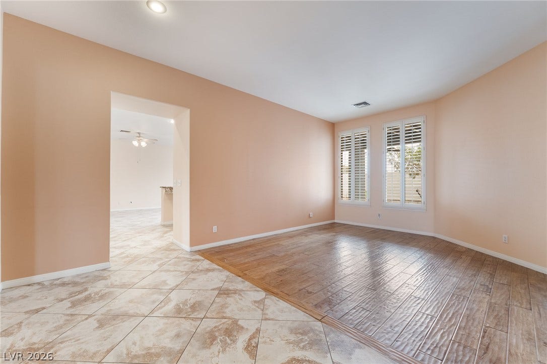 3775 Rick Stratton Drive, Las Vegas, NV 89120 A versatile living space with distinct flooring zones and ample natural light.