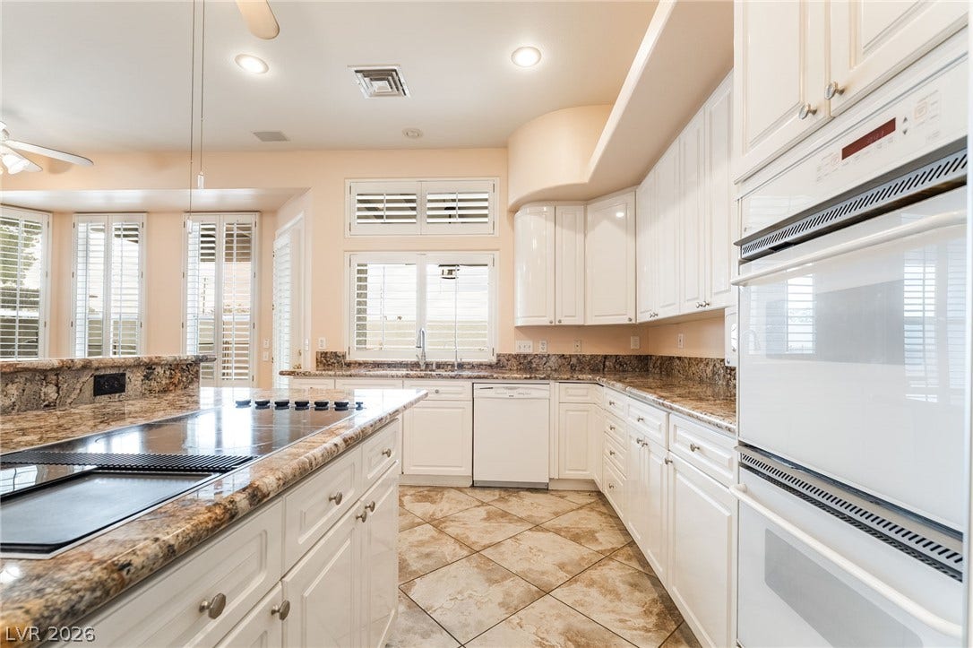 3775 Rick Stratton Drive, Las Vegas, NV 89120 Culinary aspirations come alive in this kitchen, boasting polished granite countertops and abundant white cabinetry.