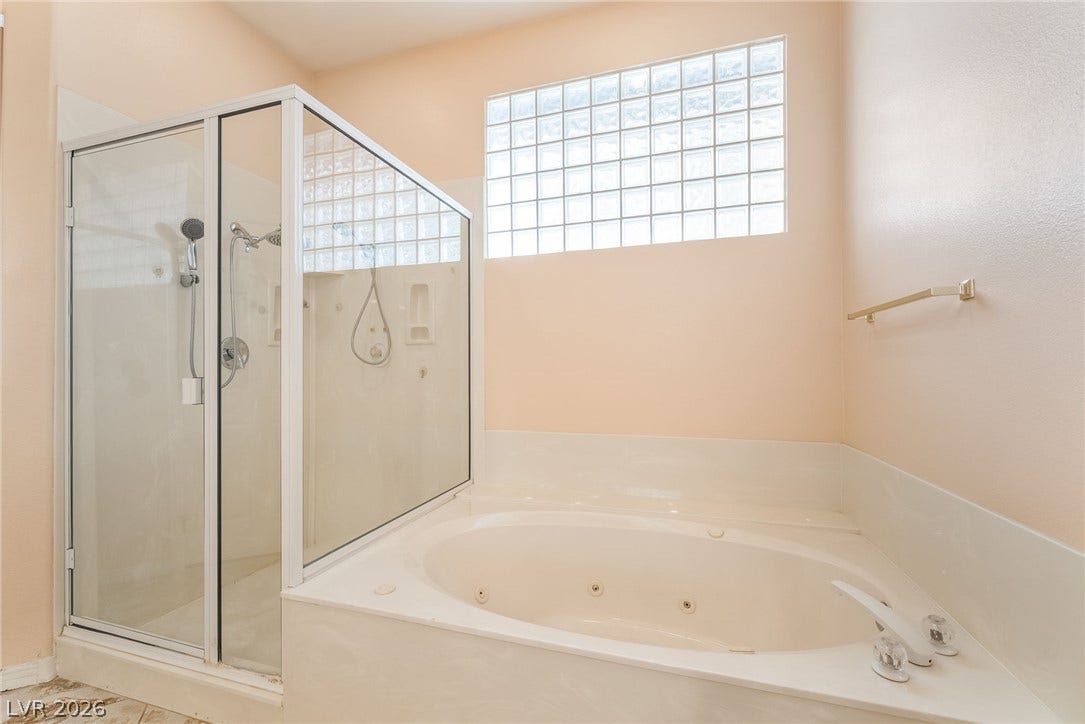 3775 Rick Stratton Drive, Las Vegas, NV 89120 Relaxing jetted tub and a spacious glass-enclosed shower.