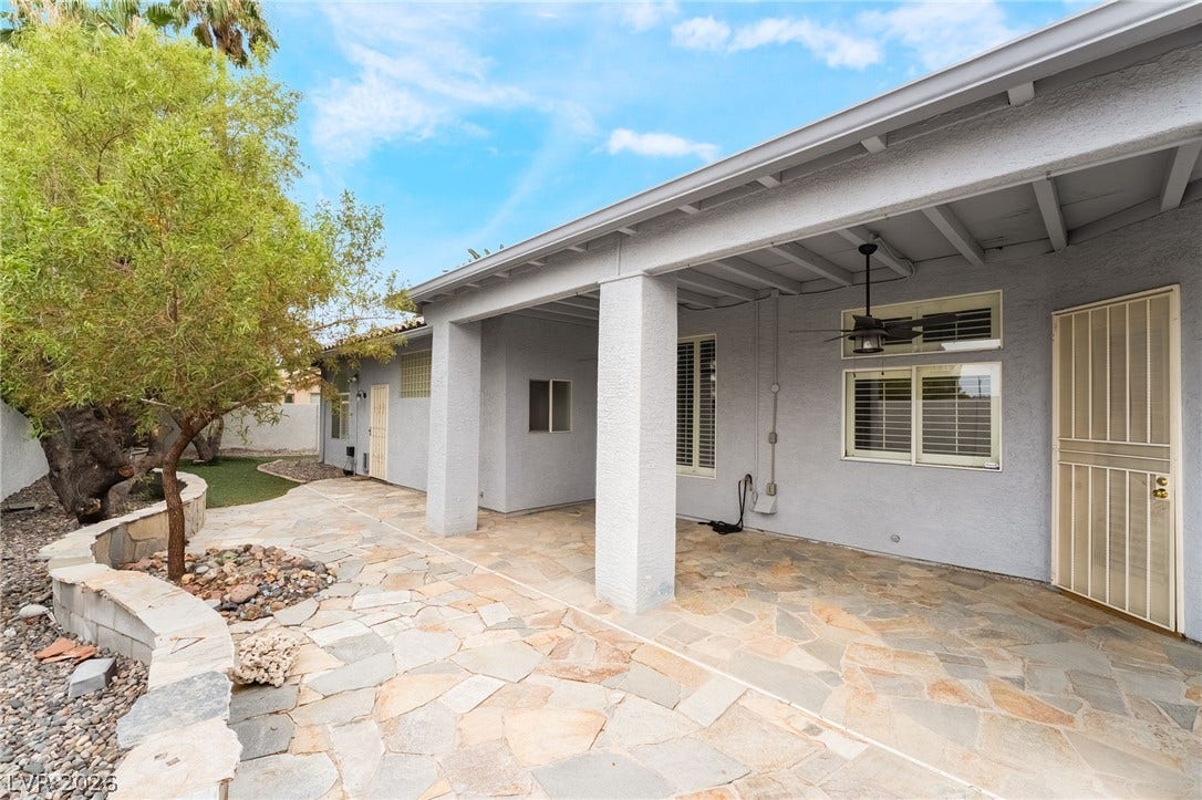 3775 Rick Stratton Drive, Las Vegas, NV 89120 A spacious flagstone patio invites outdoor living, complete with covered areas for shaded relaxation.