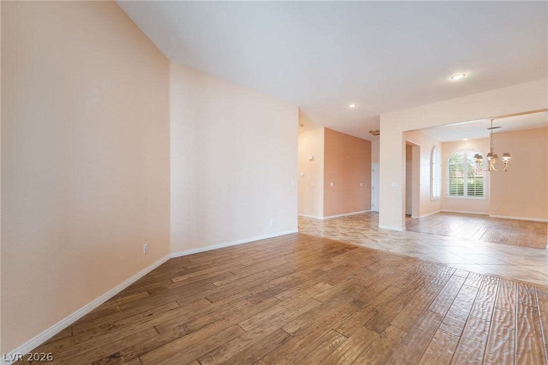 3775 Rick Stratton Drive, Las Vegas, NV 89120 Step into this spacious living area featuring wood-look tile flooring and recessed lighting throughout.