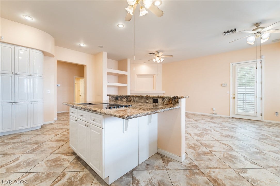 3775 Rick Stratton Drive, Las Vegas, NV 89120 A well-lit kitchen with a central island and a functional cooktop.