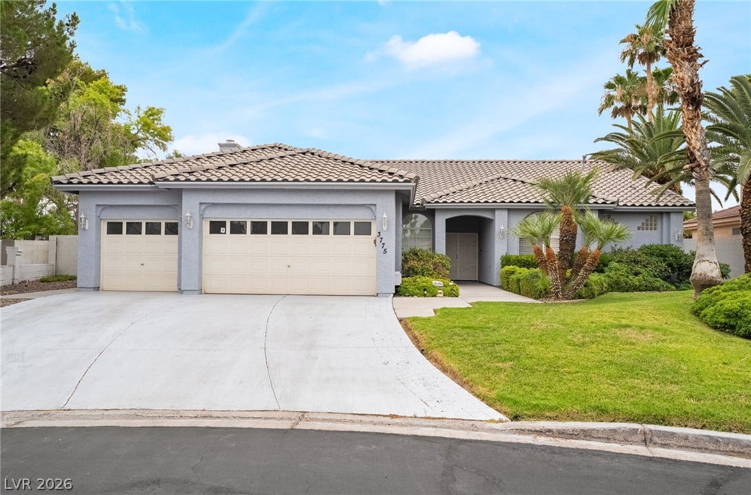 3775 Rick Stratton Drive, Las Vegas, NV 89120 A classic tiled roof tops this inviting home, featuring a spacious driveway leading to a two-car garage.