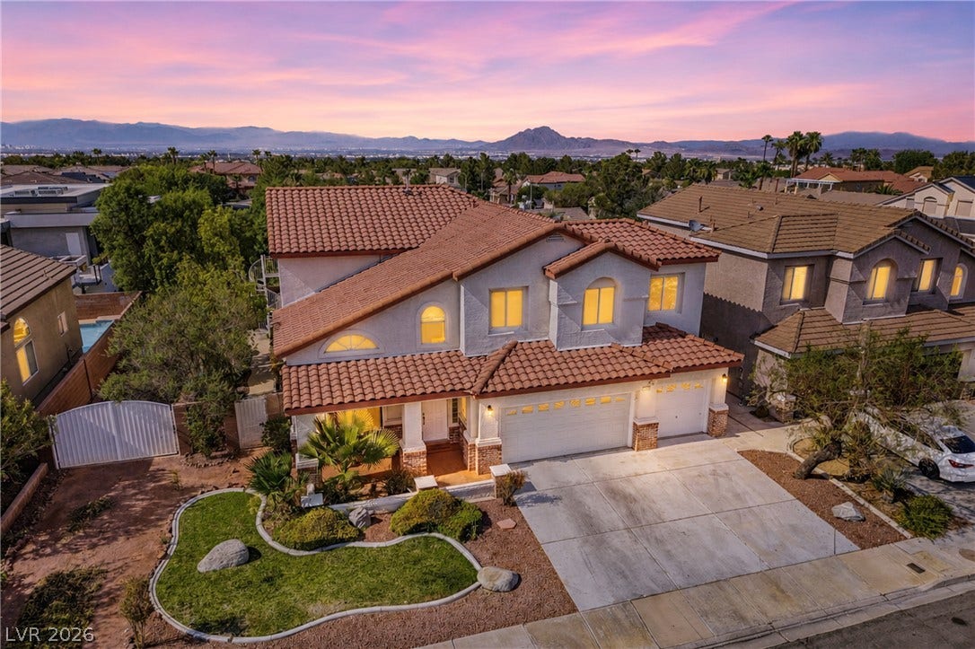2218 Alanhurst Drive, Henderson, NV 89052 A terracotta-tiled roof and stucco exterior greet you, offering inviting curb appeal with a landscaped front yard.