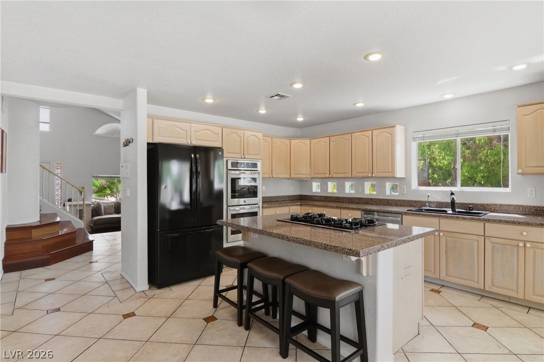 2218 Alanhurst Drive, Henderson, NV 89052 A well-appointed kitchen features a central island, modern appliances, and a seamless flow into adjacent living areas.