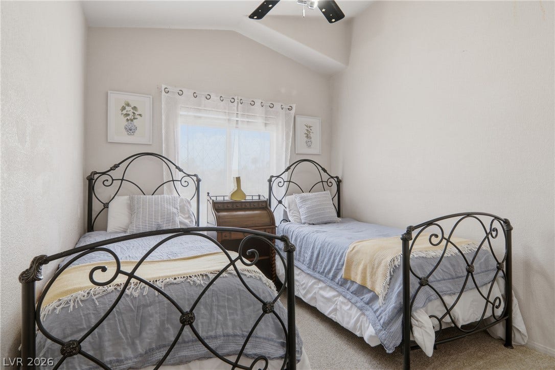 2218 Alanhurst Drive, Henderson, NV 89052 A well-lit bedroom features vaulted ceilings and ample space for two twin beds.