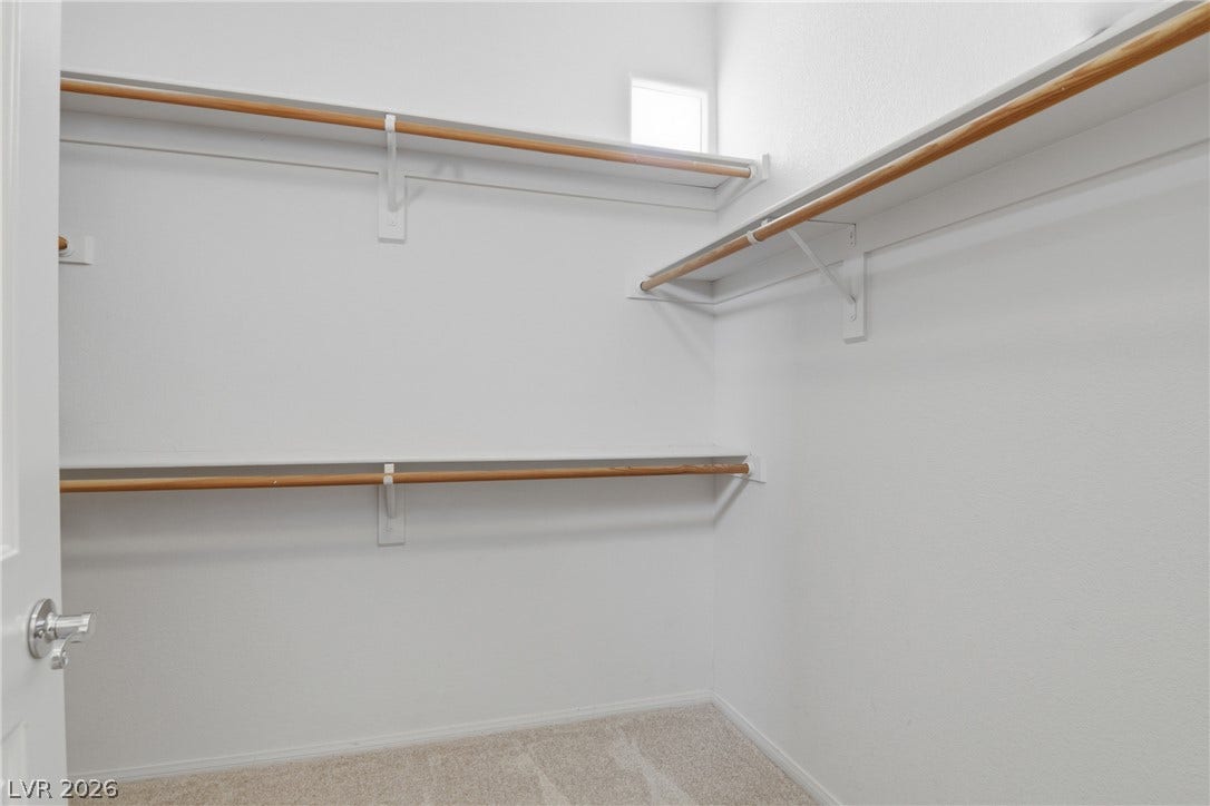 2218 Alanhurst Drive, Henderson, NV 89052 Functional shelving and hanging rods create an organized walk-in closet space.