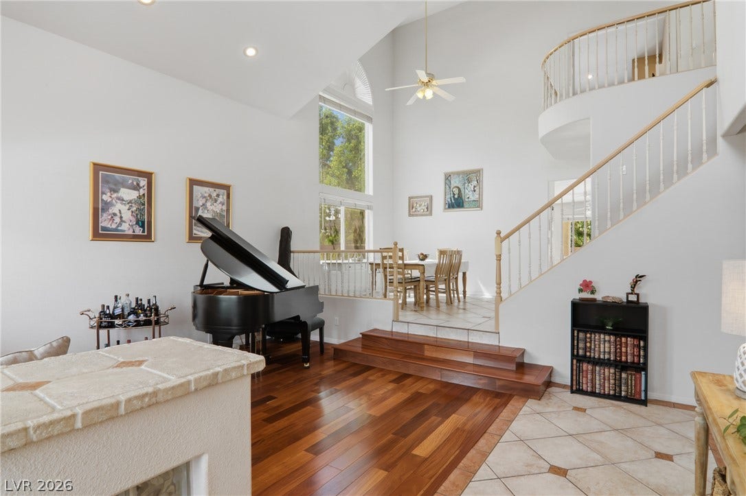 2218 Alanhurst Drive, Henderson, NV 89052 A grand living space with soaring vaulted ceilings and a captivating open staircase.