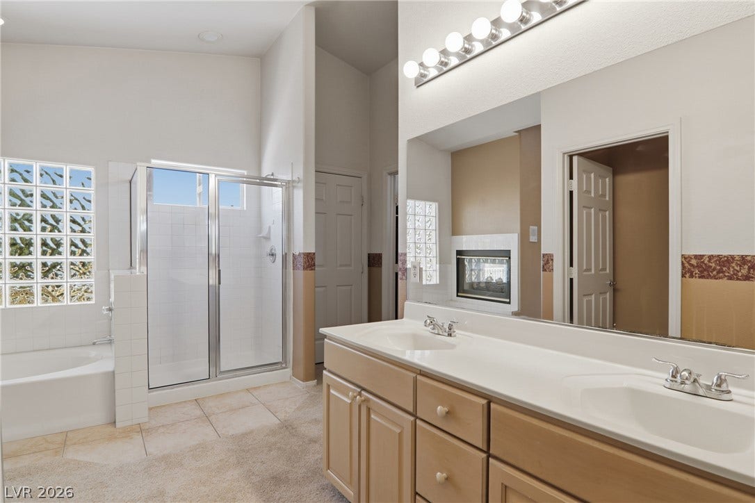 2218 Alanhurst Drive, Henderson, NV 89052 Double vanities and a spacious glass-enclosed shower create a practical bathroom retreat.