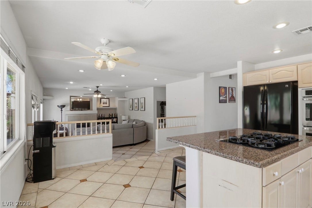 2218 Alanhurst Drive, Henderson, NV 89052 An open-concept living area with tile flooring flows seamlessly into a well-appointed kitchen.