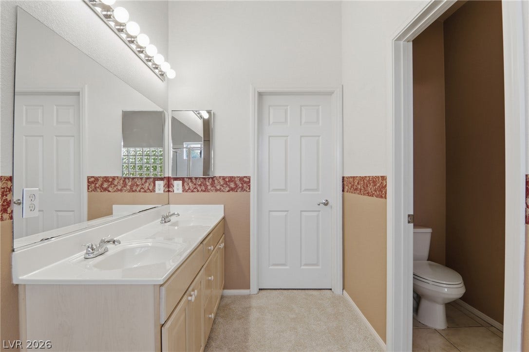 2218 Alanhurst Drive, Henderson, NV 89052 Double vanity sinks and bright lighting enhance this spacious bathroom's functionality.