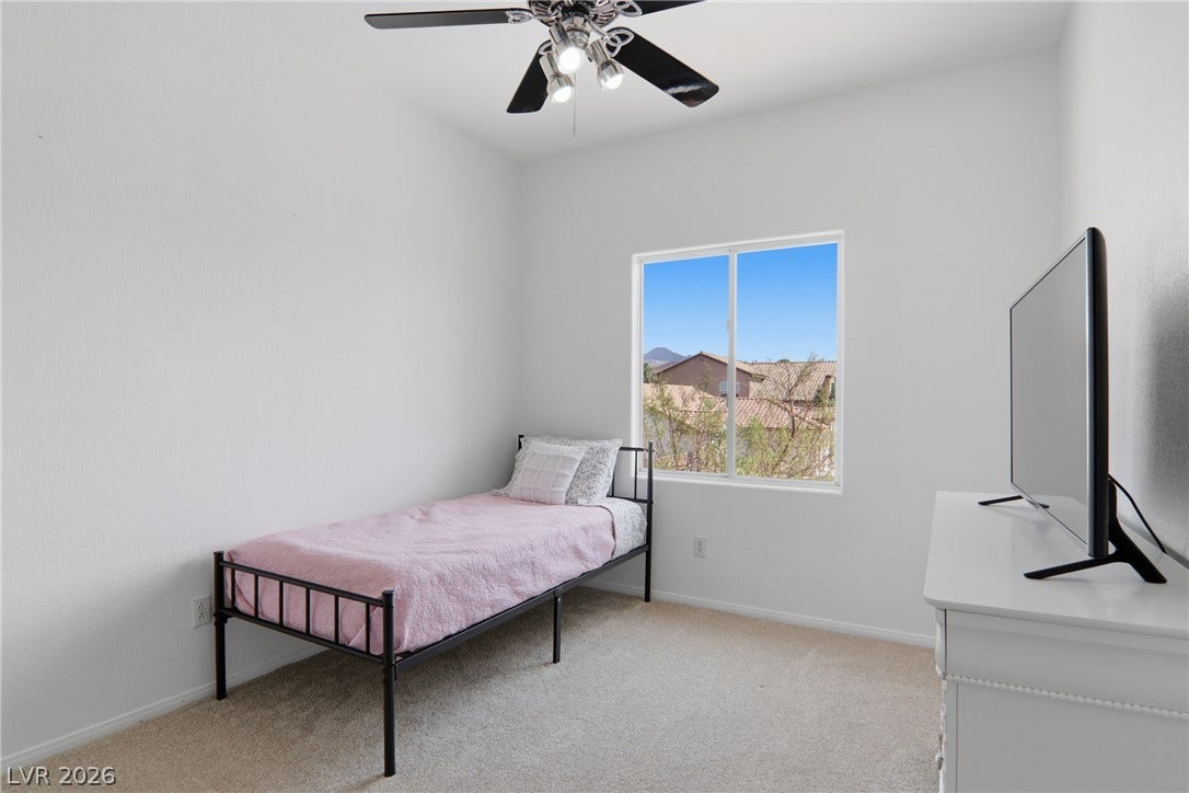 2218 Alanhurst Drive, Henderson, NV 89052 A well-lit room offers a ceiling fan and a clear window view of the neighborhood.