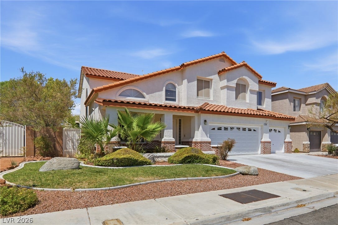 2218 Alanhurst Drive, Henderson, NV 89052 A well-maintained suburban residence features a terracotta-tiled roof and an inviting front entry.