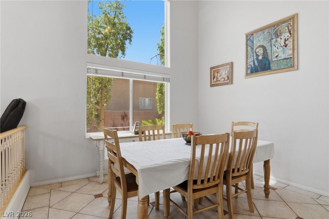 2218 Alanhurst Drive, Henderson, NV 89052 Natural light floods this dining area through generous windows, creating an inviting atmosphere for meals.