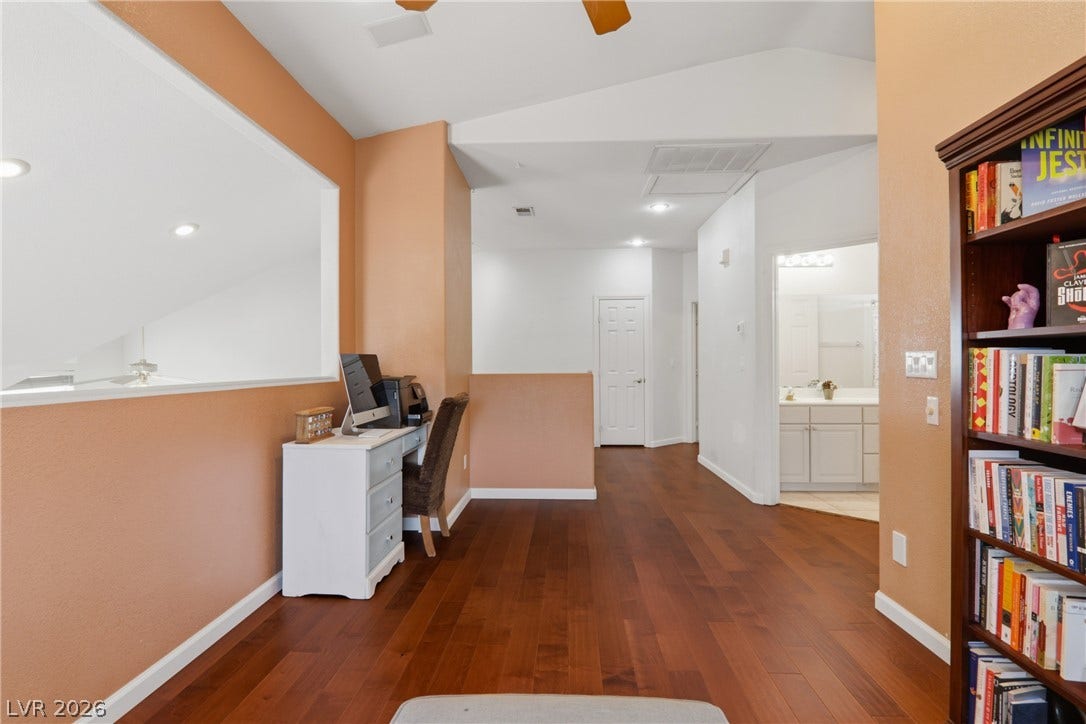 2218 Alanhurst Drive, Henderson, NV 89052 Rich wood floors define this versatile loft space, complete with a dedicated workspace and built-in shelving.