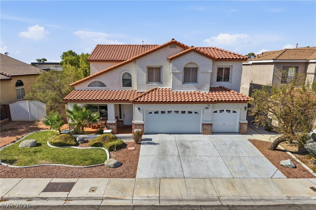 2218 Alanhurst Drive, Henderson, NV 89052 Two-story home with terracotta roof tiles and an inviting front yard featuring well-maintained landscaping.