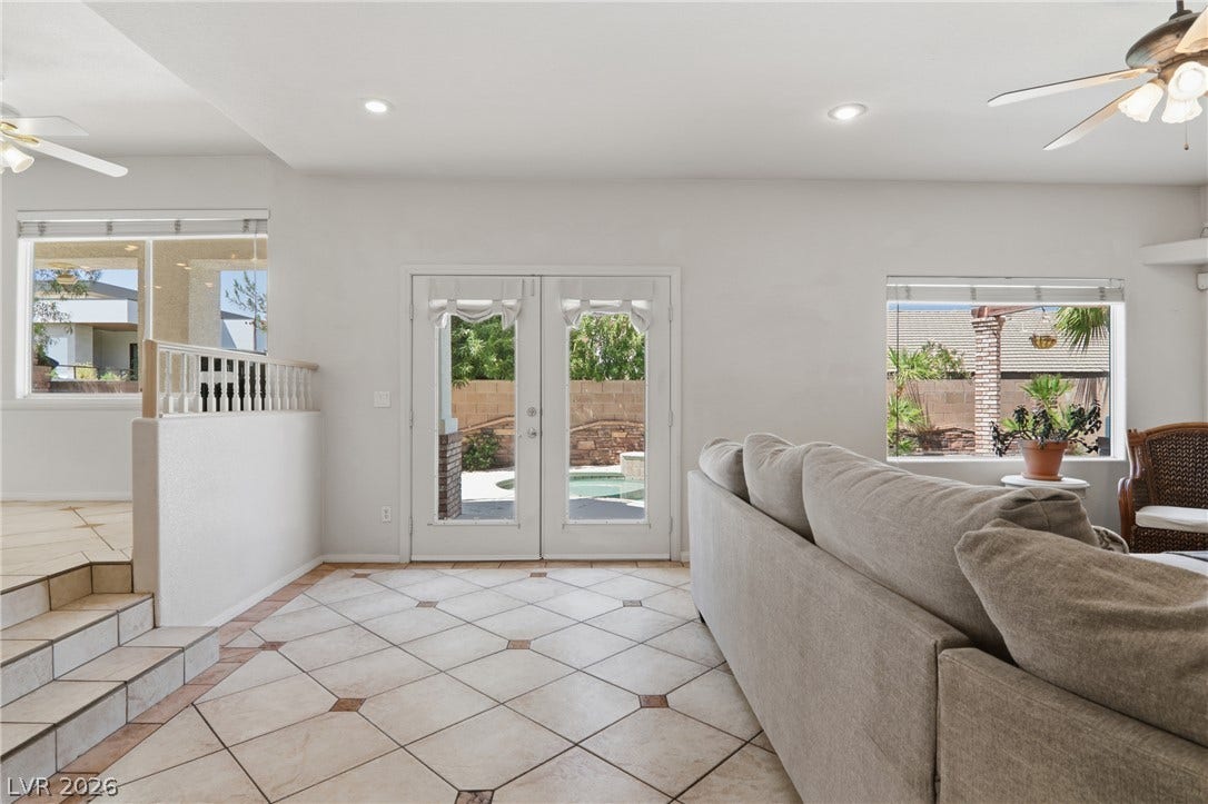 2218 Alanhurst Drive, Henderson, NV 89052 Step into a well-lit living area featuring patterned tile flooring and convenient outdoor access.