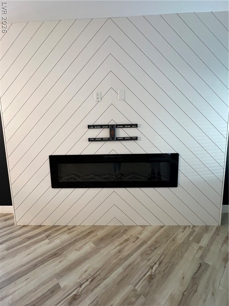 9621 Dancing Pond Way, Las Vegas, NV 89178 A stylish fireplace and modern flooring create a welcoming ambiance in this inviting living space.