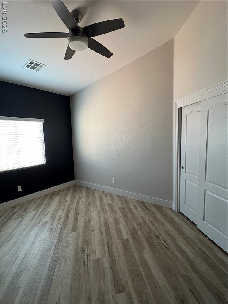 9621 Dancing Pond Way, Las Vegas, NV 89178 Streamlined wood-look flooring enhances the modern, airy interior, offering both style and comfort.