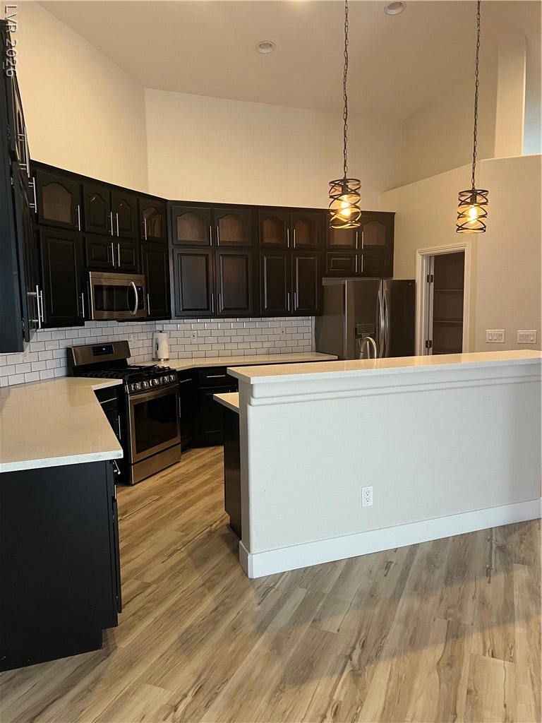9621 Dancing Pond Way, Las Vegas, NV 89178 A well-appointed kitchen features rich cabinetry, modern appliances, and a convenient center island for culinary endeavors.