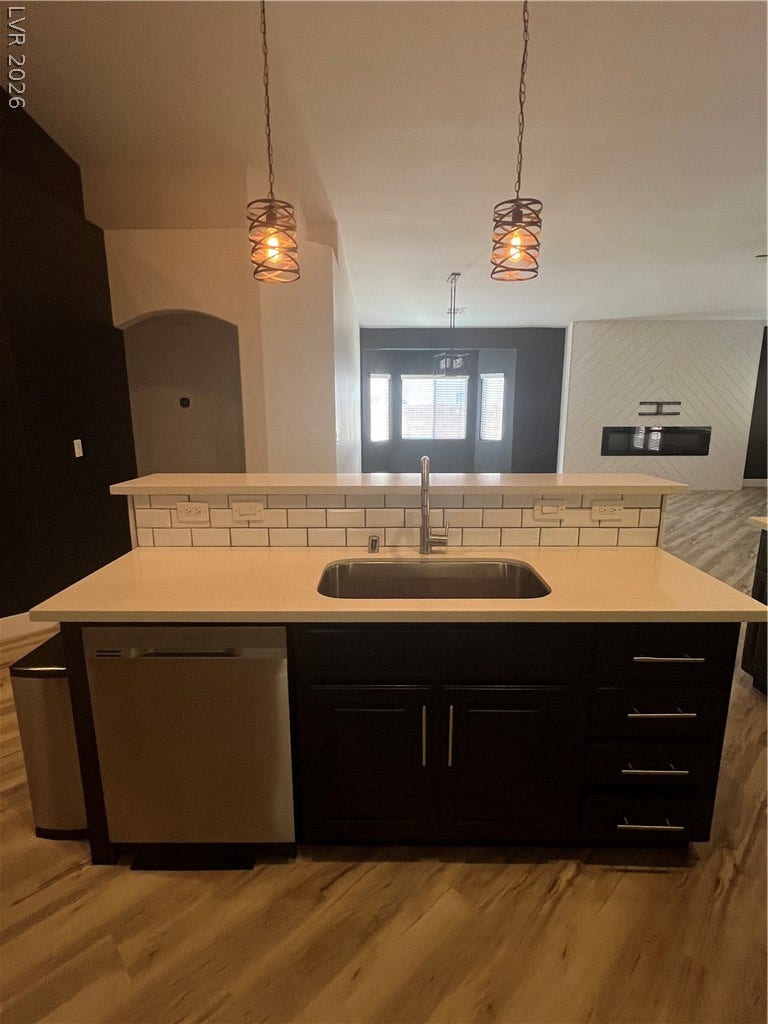 9621 Dancing Pond Way, Las Vegas, NV 89178 A well-appointed kitchen island offers a built-in sink and ample counter space, perfectly complementing the open-concept living area.