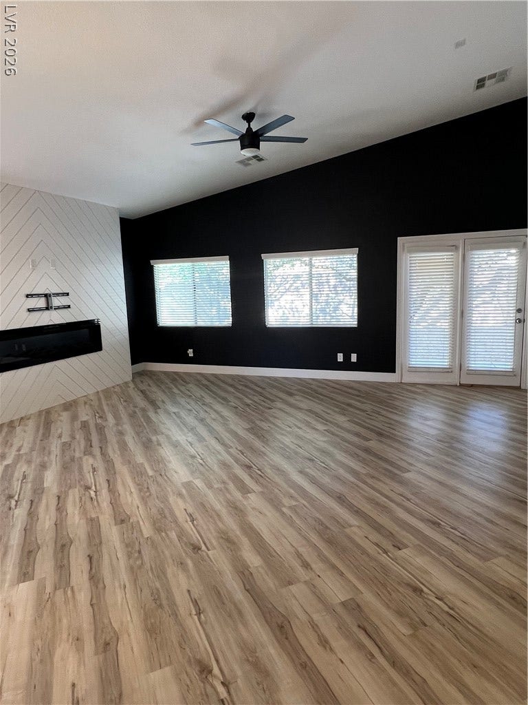 9621 Dancing Pond Way, Las Vegas, NV 89178 Laminate flooring extends through this room, complemented by the angled ceilings and abundant window light.