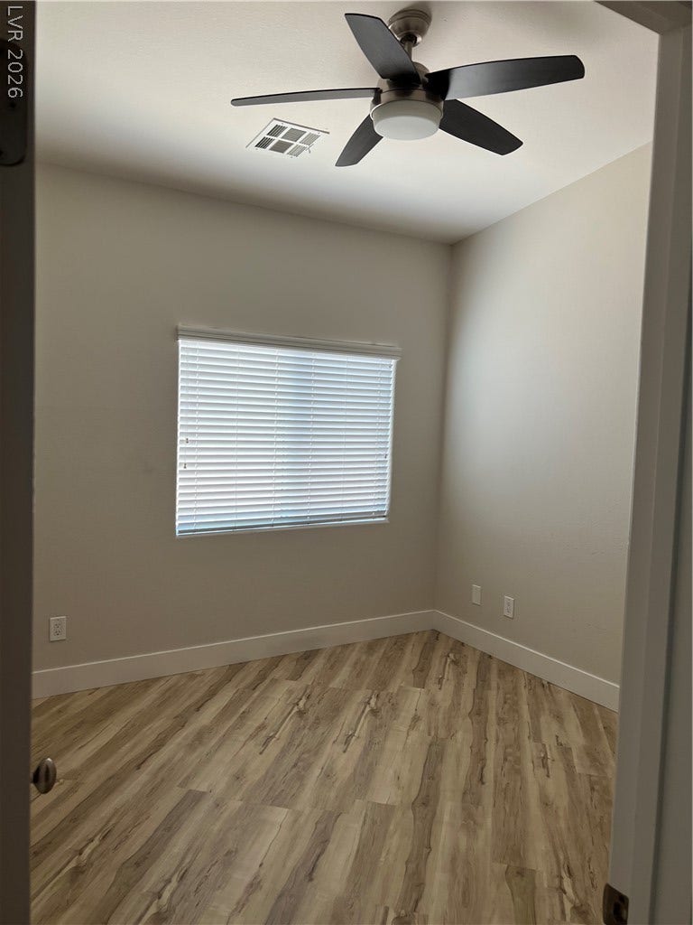 9621 Dancing Pond Way, Las Vegas, NV 89178 Clean lines and a wood-look accent wall define this contemporary space.