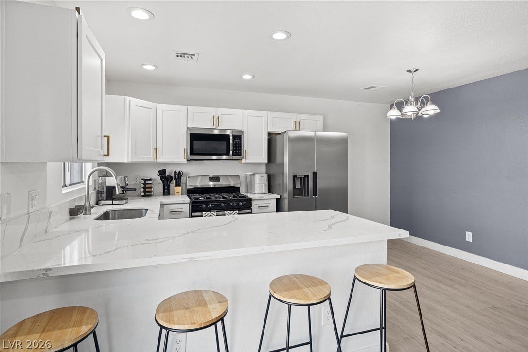 525 Van Dornum Avenue, Henderson, NV 89011 Culinary delights await in this modern kitchen, featuring pristine countertops and ample prep space.
