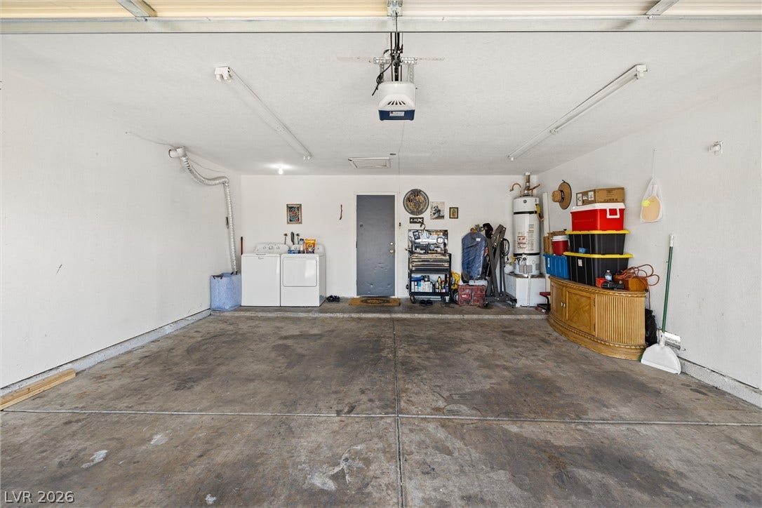 525 Van Dornum Avenue, Henderson, NV 89011 A spacious garage featuring a convenient laundry area and ample storage options.