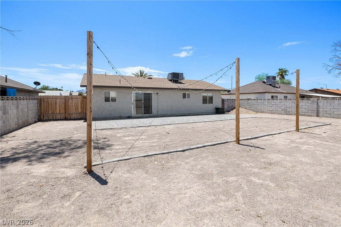 525 Van Dornum Avenue, Henderson, NV 89011 An inviting private yard featuring a spacious patio and charming string lighting for evening enjoyment.