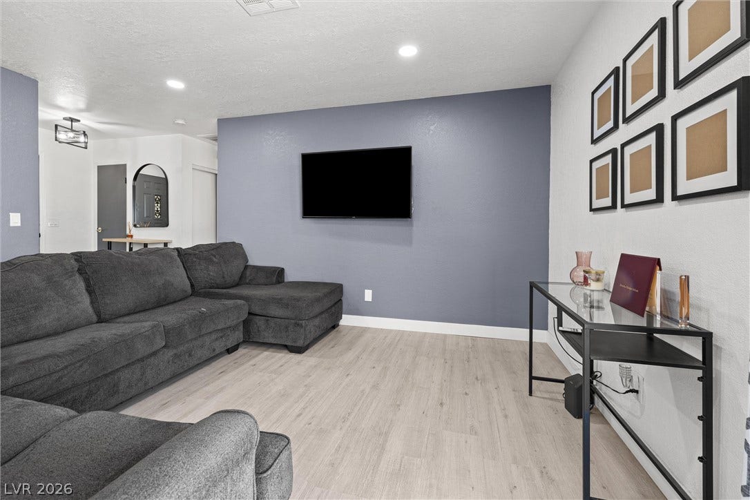 525 Van Dornum Avenue, Henderson, NV 89011 Luminous living area features recessed lighting and stylish light-toned flooring.