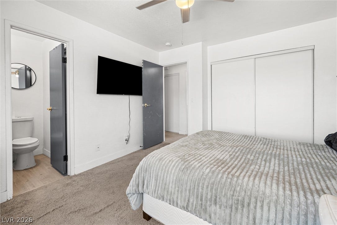 525 Van Dornum Avenue, Henderson, NV 89011 A well-lit bedroom offers direct access to a private bathroom and ample closet space.